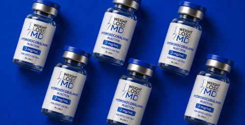 Multiple Hydroxocobalamin injection vials 2 mg/mL with Weight Loss MD branding arranged on a blue background