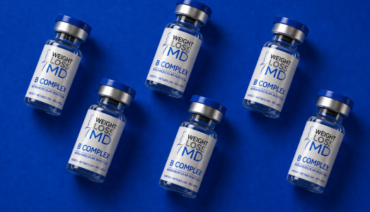 Multiple B-Complex intramuscular injection vials with Weight Loss MD branding on a blue background.